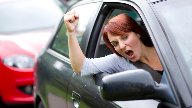 Woman gesturing out of car window